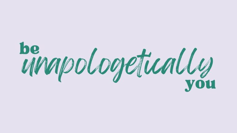 The words "be unapologetically you" are written in green across a lilac background. The "be" and "you" look like they have been typed whereas "unapologetically" looks as though it has been written with a paintbrush